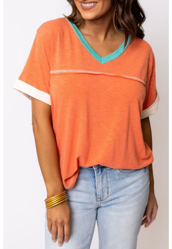 Grapefruit Orange Contrast Trim Exposed Seam
  V Neck T
  shirt
  Trendy contrast trim adds a color block effect
  Visible stitching creates a unique and fashionable look
  V
  neck cut flatters your neckline and adds a feminine touch
  Soft and breathable fabrics
  Perfect for everyday wear
  High elasticity
  Unisex
Material: 65% Polyester 35% Cotton