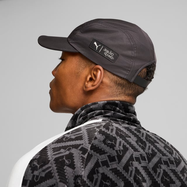 PUMA x SQUID GAME Unisex Flatbrim Cap PRODUCT STORY: Attention, players: PUMA x SQUID GAME is here. Created in anticipation of Squid Game’s second season, this collection of streetwear staples blends PUMA’s effortless sport-style with Squid Game’s iconic DNA. Look for classic T7 track suits, velour, all-over prints, and illustrative graphics inspired by elements from the show. Classic sneakers are reimagined with details from Red Light, Green Light and the iconic staircase. Part of the collection, this flatbrim cap features heat press eyelets on the sides and PUMA x SQUID GAME co-branding details. It’s time to enter the game – do you have what it takes to win? FEATURES & BENEFITS: Made with at least 30% recycled materials. DETAILS: Flatbrim style cap; Heat press eyelets on the sides; Unisex; Part of the PUMA x SQUID GAME collection; PUMA x SQUID GAME co-branding details.