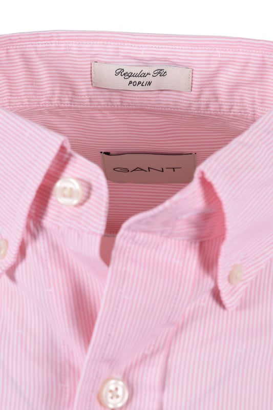 Gant Reg Dobby Dot Stripe Shirt in Geranium Pink
Elevate your casual style with the Gant Reg Dobby Dot Stripe Shirt in a vibrant geranium pink. This shirt is expertly crafted from premium 100% cotton, offering exceptional comfort and breathability throughout the day. The unique dobby dot and yarn-dyed stripe design adds a touch of texture and visual interest, making it a standout piece in your wardrobe.   
 
Designed for a classic regular fit, this shirt features a timeless button-down collar, a practical chest pocket, and adjustable cuffs for a personalised feel. The curved hem ensures a clean and polished look, whether worn tucked or untucked.   
 
Attention to detail is paramount, with recycled polyester buttons contributing to a more sustainable approach. A subtle yet iconic GANT shield graphic is embroidered at the chest, signifying the brand's heritage and quality.
 
Features

100% Premium Cotton
Dobby Dot and Yarn-Dyed Stripe Design
Regular Fit
Button-Down Collar
Chest Pocket
Adjustable Cuffs
Curved Hem
Recycled Polyester Buttons
Embroidered GANT Shield Graphic
Style code: 3250081