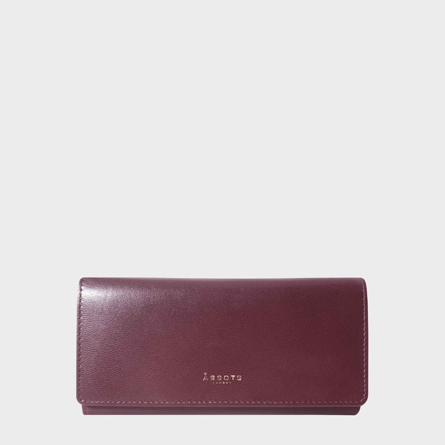 The ‘Claire’ flapover ladies purse is handcrafted with the Assots premium 'Giovani' Italian Polished vegetable tanned leather. Equipped with RFID technology, this practical ladies purse features a magnetic fastening closure with plenty of room to organise your cash, cards and coins. This large leather ladies purse is perfect to compliment your handbag and fits in easily. Stay safe and organised with ‘Claire’ the perfect addition to your collection of purses ideal for all outfits and occasions. Secured flap over magnetic fastening closure to store your essentials safely and securely. Foldover flap design. Equipped with RFID technology for safety. Additional back zip pocket to ensure you don’t run out of space. Two note compartments. Eight internal card compartments. Two windowed ID slots.Assots branded lined interiors. Lightweight for easy carry. Fittings Colour: Clean Brass. Composition: Body: 100% Genuine Leather. Lining: 100% Cotton. DISCLAIMER : All pictures shown are for illustration purpose only. Actual product colour may vary due to different ambience lighting or the screen display settings. Size - W20cm x H10.5cm x D2.5cm.