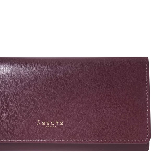The ‘Claire’ flapover ladies purse is handcrafted with the Assots premium 'Giovani' Italian Polished vegetable tanned leather. Equipped with RFID technology, this practical ladies purse features a magnetic fastening closure with plenty of room to organise your cash, cards and coins. This large leather ladies purse is perfect to compliment your handbag and fits in easily. Stay safe and organised with ‘Claire’ the perfect addition to your collection of purses ideal for all outfits and occasions. Secured flap over magnetic fastening closure to store your essentials safely and securely. Foldover flap design. Equipped with RFID technology for safety. Additional back zip pocket to ensure you don’t run out of space. Two note compartments. Eight internal card compartments. Two windowed ID slots.Assots branded lined interiors. Lightweight for easy carry. Fittings Colour: Clean Brass. Composition: Body: 100% Genuine Leather. Lining: 100% Cotton. DISCLAIMER : All pictures shown are for illustration purpose only. Actual product colour may vary due to different ambience lighting or the screen display settings. Size - W20cm x H10.5cm x D2.5cm.