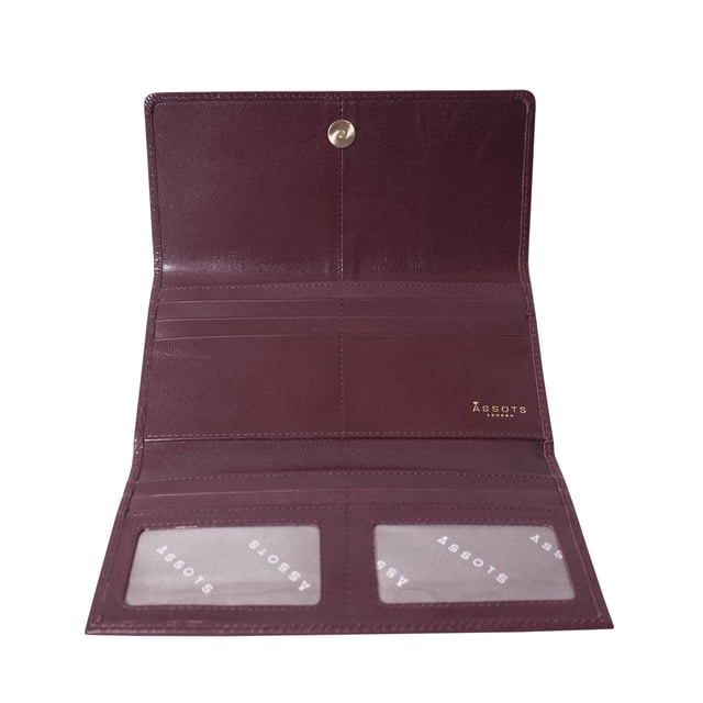 The ‘Claire’ flapover ladies purse is handcrafted with the Assots premium 'Giovani' Italian Polished vegetable tanned leather. Equipped with RFID technology, this practical ladies purse features a magnetic fastening closure with plenty of room to organise your cash, cards and coins. This large leather ladies purse is perfect to compliment your handbag and fits in easily. Stay safe and organised with ‘Claire’ the perfect addition to your collection of purses ideal for all outfits and occasions. Secured flap over magnetic fastening closure to store your essentials safely and securely. Foldover flap design. Equipped with RFID technology for safety. Additional back zip pocket to ensure you don’t run out of space. Two note compartments. Eight internal card compartments. Two windowed ID slots.Assots branded lined interiors. Lightweight for easy carry. Fittings Colour: Clean Brass. Composition: Body: 100% Genuine Leather. Lining: 100% Cotton. DISCLAIMER : All pictures shown are for illustration purpose only. Actual product colour may vary due to different ambience lighting or the screen display settings. Size - W20cm x H10.5cm x D2.5cm.