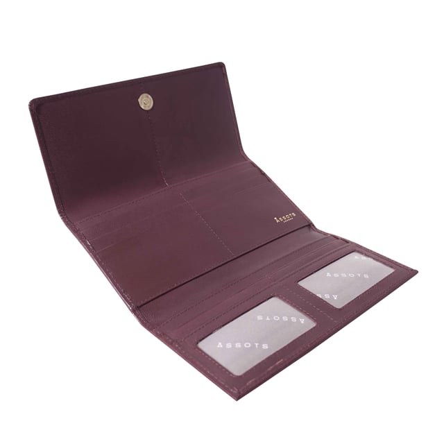The ‘Claire’ flapover ladies purse is handcrafted with the Assots premium 'Giovani' Italian Polished vegetable tanned leather. Equipped with RFID technology, this practical ladies purse features a magnetic fastening closure with plenty of room to organise your cash, cards and coins. This large leather ladies purse is perfect to compliment your handbag and fits in easily. Stay safe and organised with ‘Claire’ the perfect addition to your collection of purses ideal for all outfits and occasions. Secured flap over magnetic fastening closure to store your essentials safely and securely. Foldover flap design. Equipped with RFID technology for safety. Additional back zip pocket to ensure you don’t run out of space. Two note compartments. Eight internal card compartments. Two windowed ID slots.Assots branded lined interiors. Lightweight for easy carry. Fittings Colour: Clean Brass. Composition: Body: 100% Genuine Leather. Lining: 100% Cotton. DISCLAIMER : All pictures shown are for illustration purpose only. Actual product colour may vary due to different ambience lighting or the screen display settings. Size - W20cm x H10.5cm x D2.5cm.