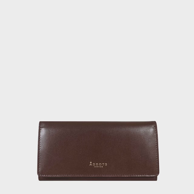 The ‘Claire’ flapover ladies purse is handcrafted with the Assots premium 'Giovani' Italian Polished vegetable tanned leather. Equipped with RFID technology, this practical ladies purse features a magnetic fastening closure with plenty of room to organise your cash, cards and coins. This large leather ladies purse is perfect to compliment your handbag and fits in easily. Stay safe and organised with ‘Claire’ the perfect addition to your collection of purses ideal for all outfits and occasions.
Secured flap over magnetic fastening closure to store your essentials safely and securely. Foldover flap design. Equipped with RFID technology for safety.
Additional back zip pocket to ensure you don’t run out of space. Two note compartments. Eight internal card compartments. Two windowed ID slots.Assots branded lined interiors. Lightweight for easy carry. Fittings Colour: Clean Brass. Composition: Body: 100% Genuine Leather. Lining: 100% Cotton.
DISCLAIMER : All pictures shown are for illustration purpose only. Actual product colour may vary due to different ambience lighting or the screen display settings. Size - W20cm x H10.5cm x D2.5cm.