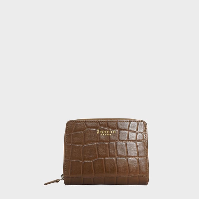 The 'Jolly' compact RFID equipped wallet purse is perfectly handcrafted with premium vintage Croc real leather for that designer look. This timeless design wallet purse easily fits in your bag or pocket featuring multiple card slots, slip pockets and a zip pocket. Organise your belongings with ease with 'Jolly' the perfect medium sized wallet purse.
Riveted closure for safe and secure storage. Zip compartment for you to store your coins and keys. Equipped with RFID technology to keep you safe from modern theft. Three card slots and three slip pockets for you to store your cards and notes. Compact size fitting easily in your bag or pocket. Fittings: Clean Brass. Composition: Body: 100% Genuine Leather. Lining: Polyester.
DISCLAIMER : All pictures shown are for illustration purpose only. Actual product colour may vary due to different ambience lighting or the screen display settings. Size- W11cm x H9.5cm x D2cm.