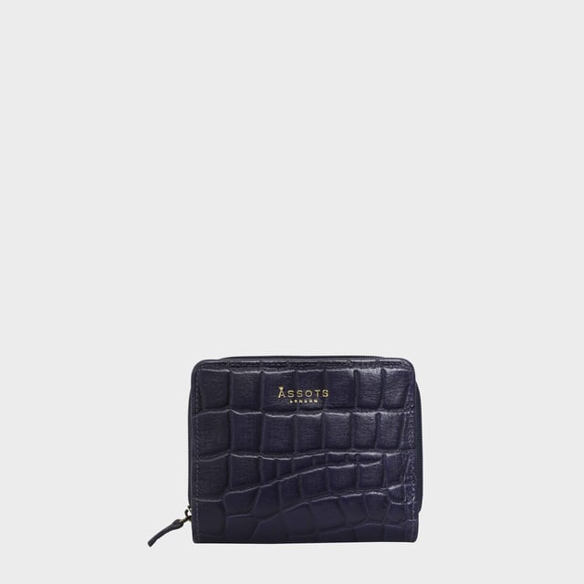 The 'Jolly' compact RFID equipped wallet purse is perfectly handcrafted with premium vintage Croc real leather for that designer look. This timeless design wallet purse easily fits in your bag or pocket featuring multiple card slots, slip pockets and a zip pocket. Organise your belongings with ease with 'Jolly' the perfect medium sized wallet purse.
Riveted closure for safe and secure storage. Zip compartment for you to store your coins and keys. Equipped with RFID technology to keep you safe from modern theft. Three card slots and three slip pockets for you to store your cards and notes. Compact size fitting easily in your bag or pocket. Fittings: Clean Brass. Composition: Body: 100% Genuine Leather. Lining: Polyester.
DISCLAIMER : All pictures shown are for illustration purpose only. Actual product colour may vary due to different ambience lighting or the screen display settings. Size- W11cm x H9.5cm x D2cm.