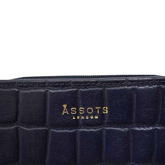 The 'Jolly' compact RFID equipped wallet purse is perfectly handcrafted with premium vintage Croc real leather for that designer look. This timeless design wallet purse easily fits in your bag or pocket featuring multiple card slots, slip pockets and a zip pocket. Organise your belongings with ease with 'Jolly' the perfect medium sized wallet purse.
Riveted closure for safe and secure storage. Zip compartment for you to store your coins and keys. Equipped with RFID technology to keep you safe from modern theft. Three card slots and three slip pockets for you to store your cards and notes. Compact size fitting easily in your bag or pocket. Fittings: Clean Brass. Composition: Body: 100% Genuine Leather. Lining: Polyester.
DISCLAIMER : All pictures shown are for illustration purpose only. Actual product colour may vary due to different ambience lighting or the screen display settings. Size- W11cm x H9.5cm x D2cm.