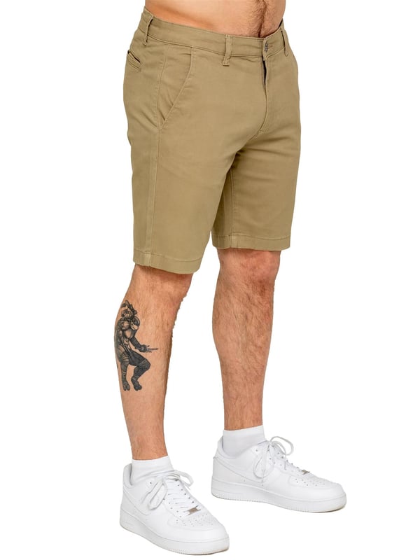 Upgrade your warm-weather wardrobe with the Enzo Men's Chino Shorts, designed for both style and comfort. Featuring a slim fit and crafted from stretch fabric, these shorts offer ease of movement and a sleek look. Practicality meets sophistication with two side slash pockets and two back welt pockets, providing ample storage for your essentials. The zip fly fastening ensures a secure and classic finish. (647)