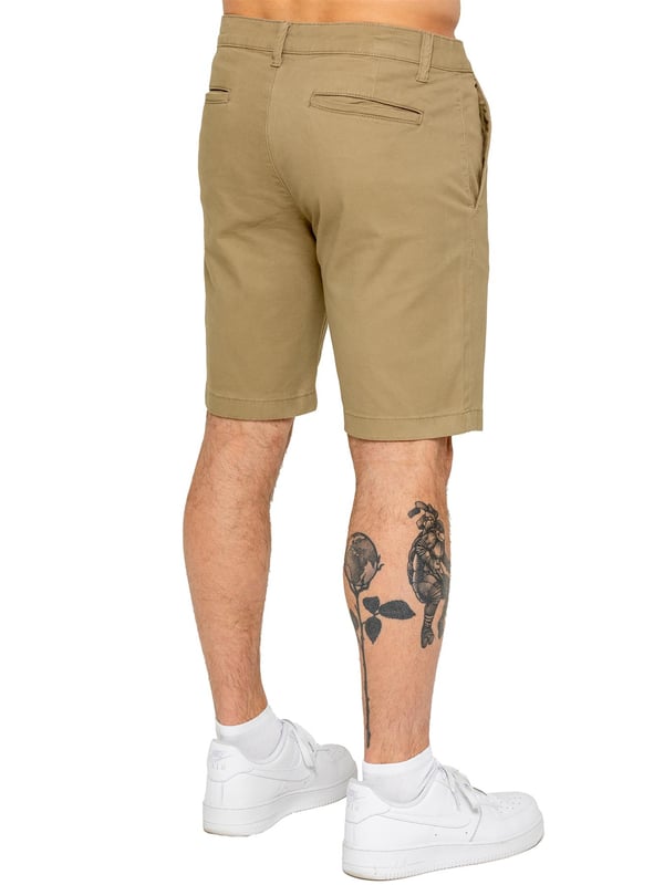 Upgrade your warm-weather wardrobe with the Enzo Men's Chino Shorts, designed for both style and comfort. Featuring a slim fit and crafted from stretch fabric, these shorts offer ease of movement and a sleek look. Practicality meets sophistication with two side slash pockets and two back welt pockets, providing ample storage for your essentials. The zip fly fastening ensures a secure and classic finish. (647)