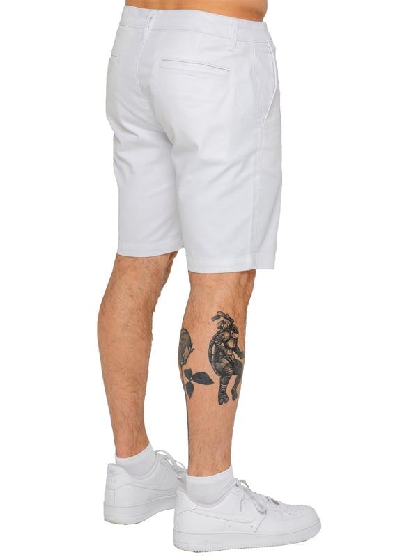Upgrade your warm-weather wardrobe with the Enzo Men's Chino Shorts, designed for both style and comfort. Featuring a slim fit and crafted from stretch fabric, these shorts offer ease of movement and a sleek look. Practicality meets sophistication with two side slash pockets and two back welt pockets, providing ample storage for your essentials. The zip fly fastening ensures a secure and classic finish. (647)