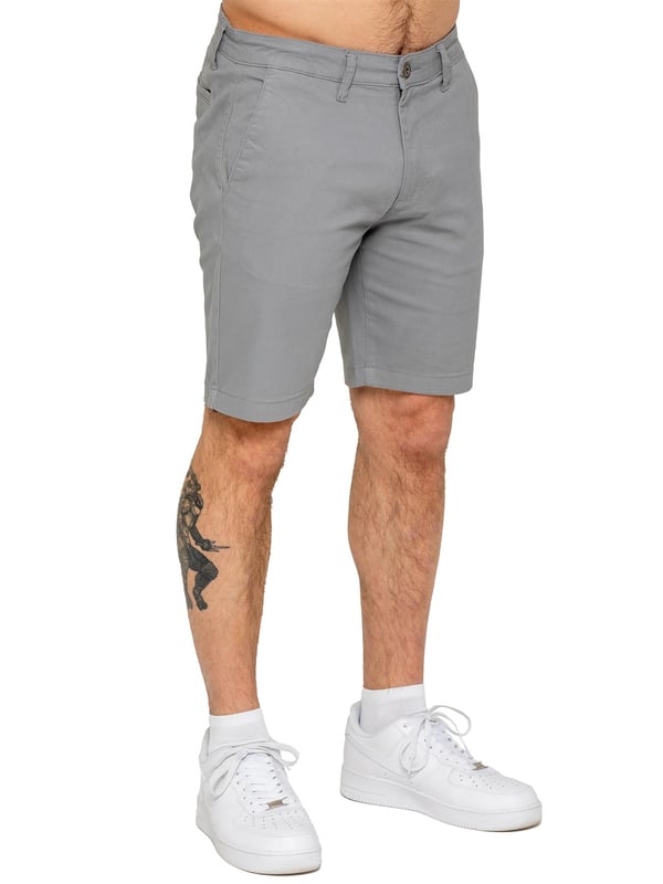 Upgrade your warm-weather wardrobe with the Enzo Men's Chino Shorts, designed for both style and comfort. Featuring a slim fit and crafted from stretch fabric, these shorts offer ease of movement and a sleek look. Practicality meets sophistication with two side slash pockets and two back welt pockets, providing ample storage for your essentials. The zip fly fastening ensures a secure and classic finish. (647)