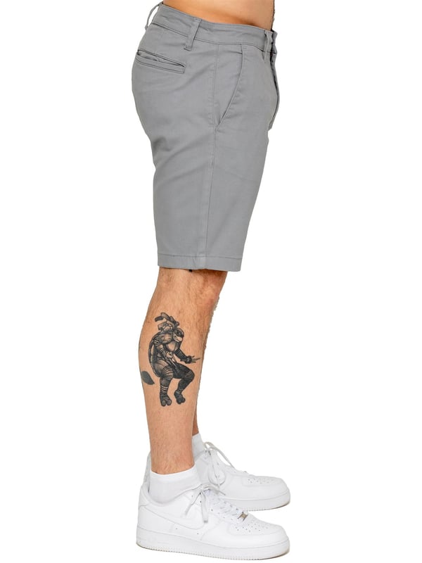 Upgrade your warm-weather wardrobe with the Enzo Men's Chino Shorts, designed for both style and comfort. Featuring a slim fit and crafted from stretch fabric, these shorts offer ease of movement and a sleek look. Practicality meets sophistication with two side slash pockets and two back welt pockets, providing ample storage for your essentials. The zip fly fastening ensures a secure and classic finish. (647)