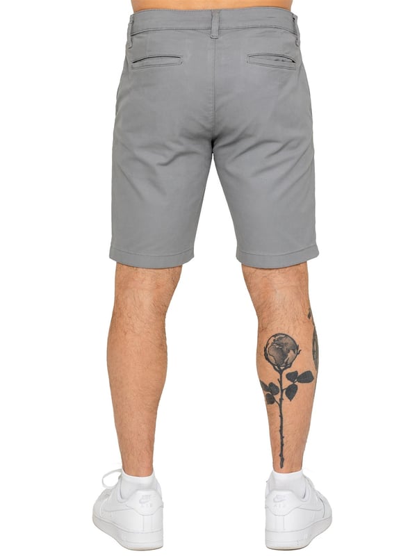 Upgrade your warm-weather wardrobe with the Enzo Men's Chino Shorts, designed for both style and comfort. Featuring a slim fit and crafted from stretch fabric, these shorts offer ease of movement and a sleek look. Practicality meets sophistication with two side slash pockets and two back welt pockets, providing ample storage for your essentials. The zip fly fastening ensures a secure and classic finish. (647)