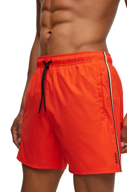 Boss Black Iconic Swim Shorts in Bright Orange
Made from quick-drying polyester, these swim shorts are both comfortable and practical. The contrasting ribbed waistband and drawstring closure provide a secure fit, while the two slit pockets and one Velcro fastening patch pocket offer plenty of storage space for your essentials.
A small printed logo on the leg adds a touch of branding, while the elasticated mesh lining provides added comfort and support.
Whether you're lounging on the beach or swimming laps in the pool, the Boss Black Iconic Swim Short in Bright Orange is the perfect way to stay cool and stylish this summer.
Michael Stewart Menswear can not accept returns on underwear, socks, swimwear or face masks for hygiene reasons. Please contact us if you need precise measurements for any item.
 