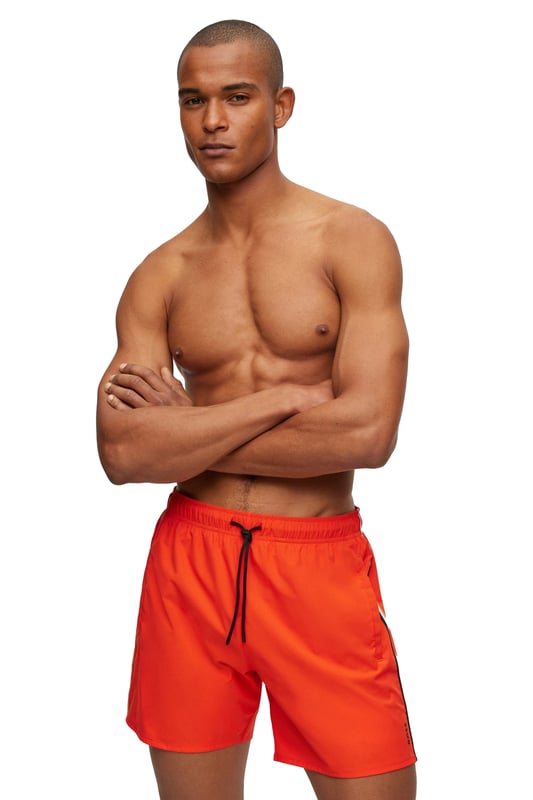 Boss Black Iconic Swim Shorts in Bright Orange
Made from quick-drying polyester, these swim shorts are both comfortable and practical. The contrasting ribbed waistband and drawstring closure provide a secure fit, while the two slit pockets and one Velcro fastening patch pocket offer plenty of storage space for your essentials.
A small printed logo on the leg adds a touch of branding, while the elasticated mesh lining provides added comfort and support.
Whether you're lounging on the beach or swimming laps in the pool, the Boss Black Iconic Swim Short in Bright Orange is the perfect way to stay cool and stylish this summer.
Michael Stewart Menswear can not accept returns on underwear, socks, swimwear or face masks for hygiene reasons. Please contact us if you need precise measurements for any item.
 