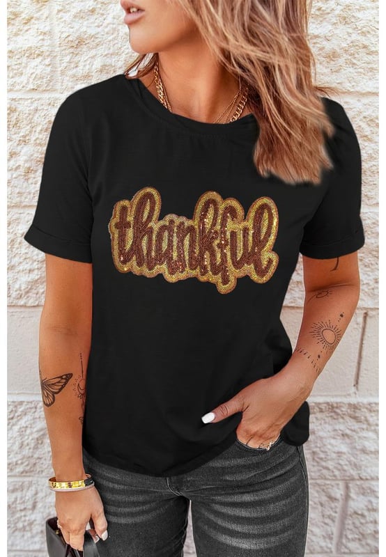 Black Sequined Thankful Round Neck Graphic Tee
  Perfect choice for the holiday season
  Round neck and shift fit for comfortable wear
  Thankful graphic with shiny sequins adds a meaningful message
  Soft and breathable material ideal for layering
  Available in multiple sizes