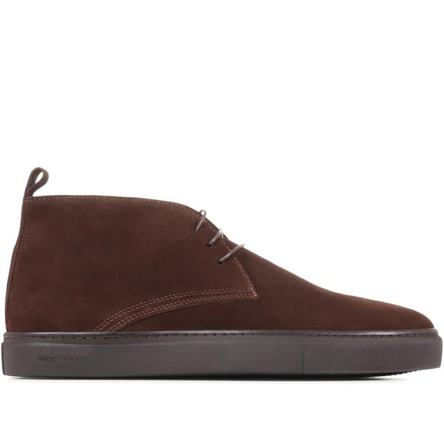 Chukka boots started out as a practical option for soldiers in the desert, these days the chukka fulfils the demands of every off-duty pursuit. Lightweight and equipped with a hardy Italian rubber sole, Sullivan features a high-cut profile crafted with supple suede, showcasing a traditional three eye-let lace-up and full leather linings, comfortable and versatile enough to serve you from work to weekend.

We recommend if you are between sizes to select the smaller than your usual.