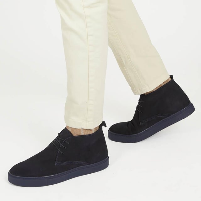 Chukka boots started out as a practical option for soldiers in the desert, these days the chukka fulfils the demands of every off-duty pursuit. Lightweight and equipped with a hardy Italian rubber sole, Sullivan features a high-cut profile crafted with supple suede, showcasing a traditional three eye-let lace-up and full leather linings, comfortable and versatile enough to serve you from work to weekend.

We recommend if you are between sizes to select the smaller than your usual.