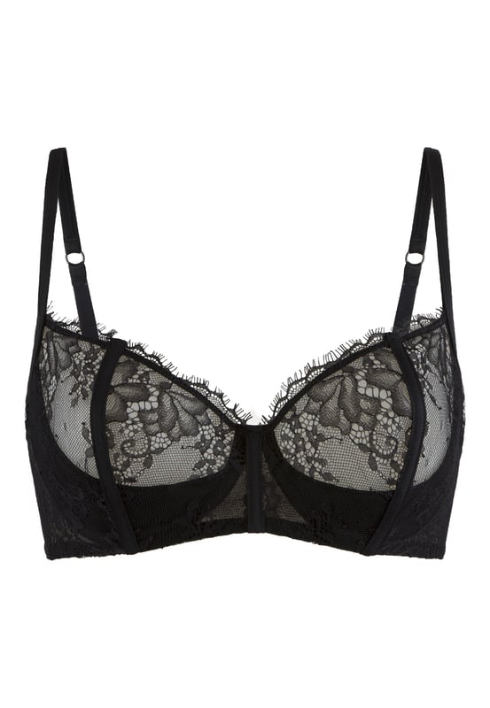 Sexy Schwarz: Verführung in der Dunkelheit. Dieser Balconett-Bügel-BH verfügt über ein Unterwire und hat transparente Spitze an den Cups. Der BH hat ein festes Unterbrustband für leichte Unterstützung.
