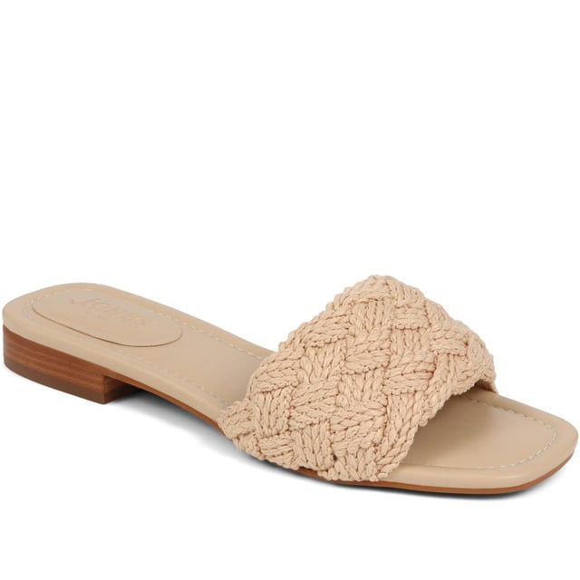 Slide into the textured embrace of these woven slide sandals, and channel artisanal charm and understated elegance. These are your go-to for a relaxed yet polished look that carries you through the summer with ease.