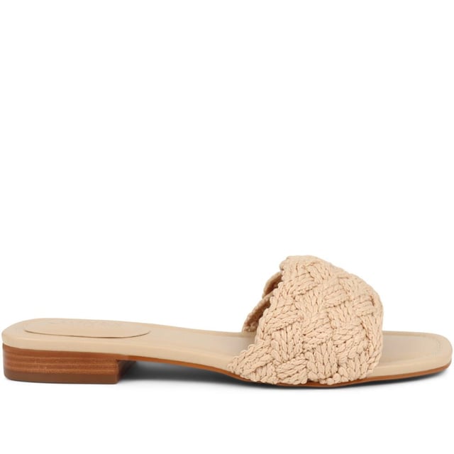 Slide into the textured embrace of these woven slide sandals, and channel artisanal charm and understated elegance. These are your go-to for a relaxed yet polished look that carries you through the summer with ease.