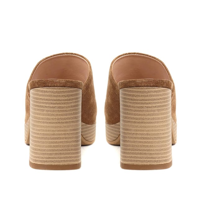 Tap into the unstoppable 90s trend with Dominica, the block heel mule that has all the nostalgic flare you need this season. Poised upon a chunky block wooden platform for added edge, these are the perfect pairing to cropped jeans, skirts or dresses.