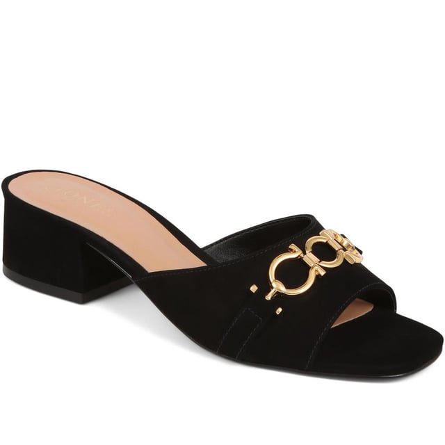 Step into effortless sophistication with these leather mules, accented with a gleaming golden chain for a hint of Jones elegance. Perfect for elevating your daytime look or complementing your evening ensemble, these heels are the epitome of chic versatility.