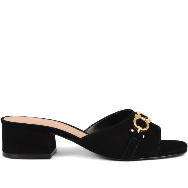 Step into effortless sophistication with these leather mules, accented with a gleaming golden chain for a hint of Jones elegance. Perfect for elevating your daytime look or complementing your evening ensemble, these heels are the epitome of chic versatility.