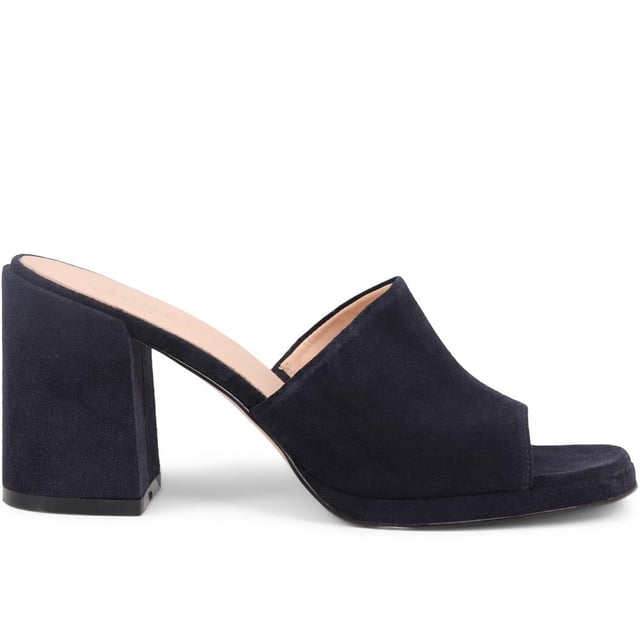 Slip into something a little more sophisticated with these leather mule sandals, boasting a luxurious suede upper and a just-right mid-height block heel. Perfect for weddings and elegant gatherings, these mules blend classic charm with contemporary chic, ensuring you step out in style.