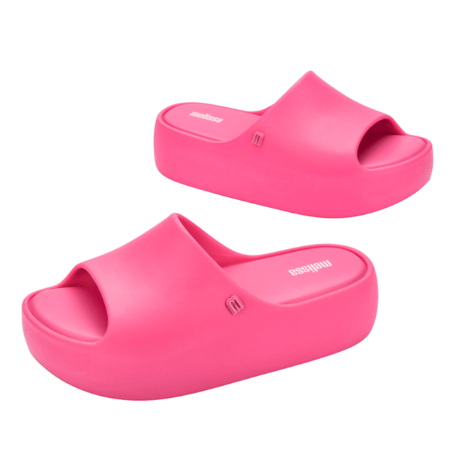 Free Platform Slide Pink Elevate the footwear game with the stylish and versatile Melissa Free Platform Slide, a style that won't let you down! The sustainable and modern Melissa Free line has delivered products that are EVA-based, lightweight, and in touch with current fashion trends. The slide has a robust design, but is unbelievably lightweight and comfortable, so much so that you will want them on ythe feet all day, every day.