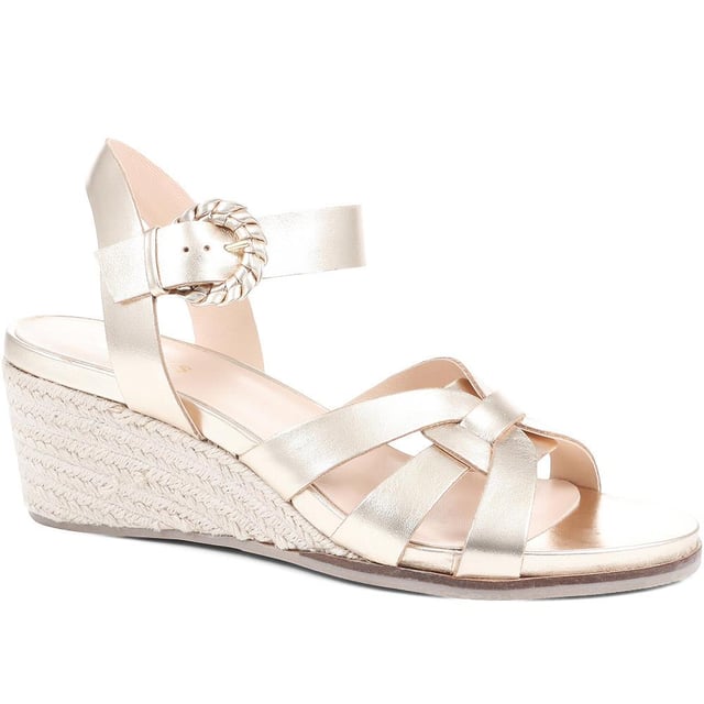 Step up your suave for those summer soirees with this beautifully feminine sandal, seated on a wedge for added comfort. With interwoven straps of leather and leather lining, you'll be on your feet in style all day with no problems.
