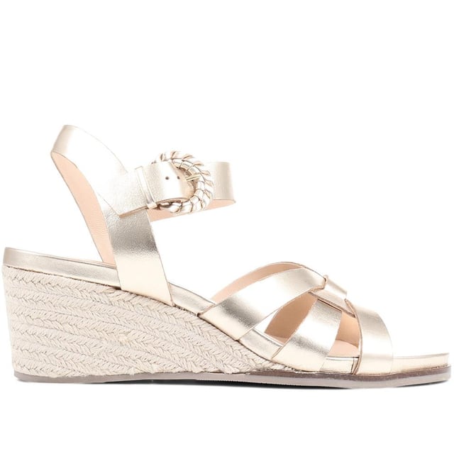 Step up your suave for those summer soirees with this beautifully feminine sandal, seated on a wedge for added comfort. With interwoven straps of leather and leather lining, you'll be on your feet in style all day with no problems.