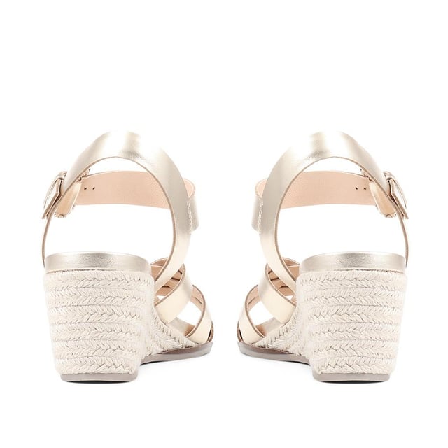 Step up your suave for those summer soirees with this beautifully feminine sandal, seated on a wedge for added comfort. With interwoven straps of leather and leather lining, you'll be on your feet in style all day with no problems.