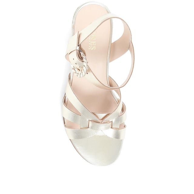 Step up your suave for those summer soirees with this beautifully feminine sandal, seated on a wedge for added comfort. With interwoven straps of leather and leather lining, you'll be on your feet in style all day with no problems.