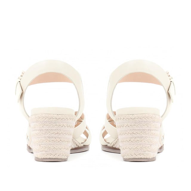 Step up your suave for those summer soirees with this beautifully feminine sandal, seated on a wedge for added comfort. With interwoven straps of leather and leather lining, you'll be on your feet in style all day with no problems.