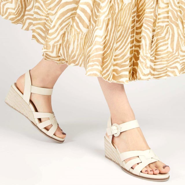Step up your suave for those summer soirees with this beautifully feminine sandal, seated on a wedge for added comfort. With interwoven straps of leather and leather lining, you'll be on your feet in style all day with no problems.