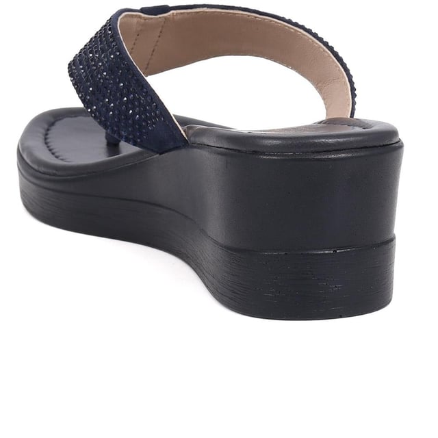 Sparkle in our toe-post wedges, adorned with a dazzling diamante upper and a comfortably mid-height heel. Ideal for carefree holiday evenings, these wedges add just the right amount of glamour to your relaxed, sun-kissed look.