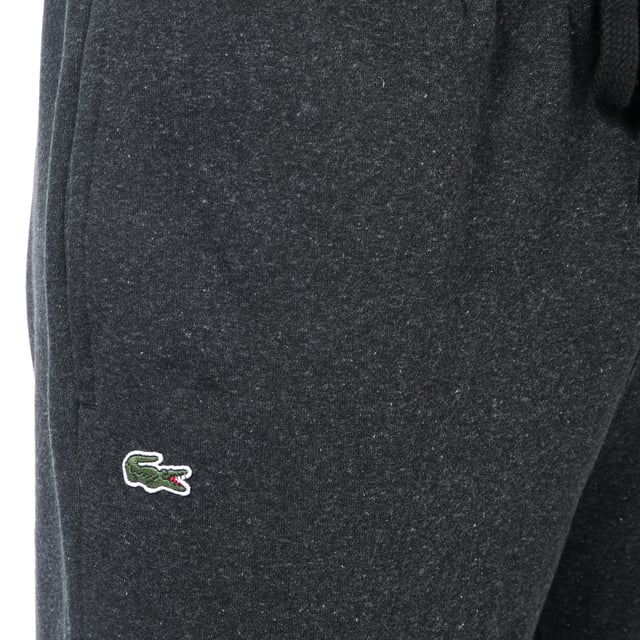 Men's Lacoste Premium Fleece Jog Pant.- 2 side pockets.- Printed Lacoste logo to front.- Fleece lined.- Crocodile logo to hem.- Elasticated waist drawstring ties to waist. Material: 87% Cotton, 13% Polyester. Ref: XH7611EL6.