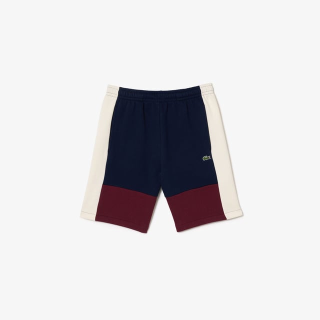 Lacoste Regular Fit Brushed Fleece Colourblock Jogger Shorts. Sporty colorblock shorts with a hip design and functional cut. Graphic style, soft texture. Urban pieces for contemporary looks, signed Lacoste.- Regular fit, straight cut.- Drawstring waist.- Side pockets.- Embroidered crocodile on front. Material: 80% Cotton, 20% Polyester. Ref: GH1319PIG.