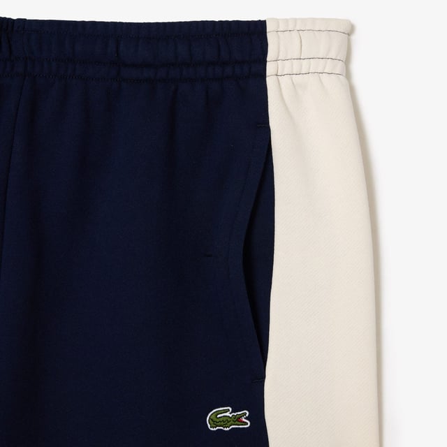 Lacoste Regular Fit Brushed Fleece Colourblock Jogger Shorts. Sporty colorblock shorts with a hip design and functional cut. Graphic style, soft texture. Urban pieces for contemporary looks, signed Lacoste.- Regular fit, straight cut.- Drawstring waist.- Side pockets.- Embroidered crocodile on front. Material: 80% Cotton, 20% Polyester. Ref: GH1319PIG.