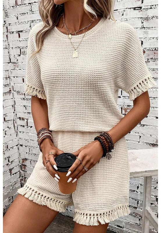 Beige two
  piece set
  Includes tee and shorts
  Textured fabric
  Fringe trim
  Chic boho vibe
  Stylish and comfy
  Perfect for daily and casual occasions
  Refer to size chart for accurate measurements.
Material: 67% Polyester 30% Viscose 3% Elastane