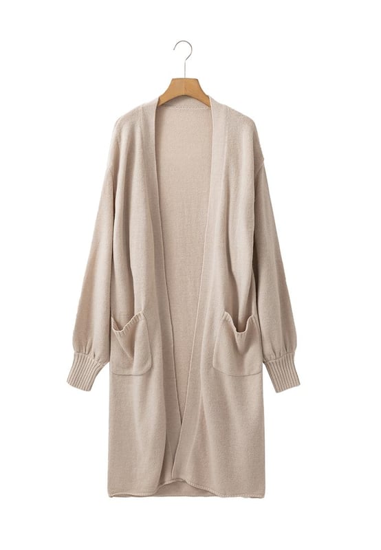 Cárdigan largo de punto con bolsillos laterales en color beige  
  Manga abullonada a la moda  
  Diseño de frente abierto  
  Fabricado con tejido de punto acogedor  
  Disponible en varias tallas  
Material: 60% Acrílico 40% Poliamida