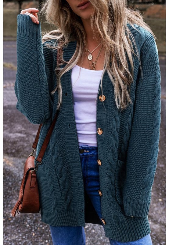 Peacock Blue Cable Knit Button Front Pocketed Baggy Cardigan
  Classic detailing
  Button
  up front
  Side pockets
  Long sleeves
  Captivating patterns and textures
  Refer to size chart for the perfect fit
Material: 65% Acrylic 35% Polyamide