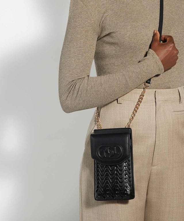 Fitted with a front compartment to slip your smartphone into and an extra side zipped pocket for your keys and a back pocket for your cards, this slimline pouch is suspended from a part chain detail cross-body strap. The front features our embossed logo.