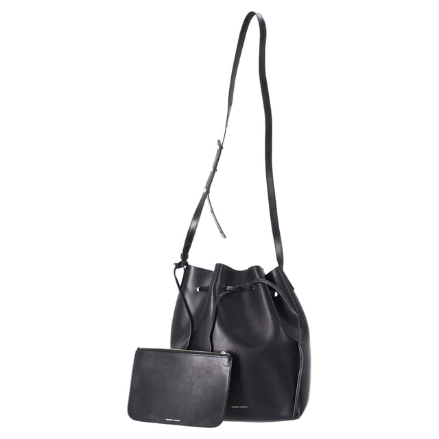 VINTAGE, RRP AS NEW
 The Mansur Gavriel Large Bucket Bag with Pouch in Black Leather is the epitome of understated luxury. Crafted from supple black leather, this spacious bag features a minimalist design with a sleek, cylindrical silhouette. The versatile bag comes with a detachable pouch for added organization, offering both style and practicality. With its smooth leather finish and timeless black color, this bag easily transitions from day to night, making it the perfect everyday accessory for the modern, fashion-conscious individual.

Styling Tip: Pair this elegant bucket bag with a tailored blazer and straight-leg trousers for a chic office look or opt for a flowy dress and ankle boots for a relaxed, weekend ensemble. Its simple design makes it easy to accessorize with bold jewelry or scarves, adding a personalized touch. The classic black leather ensures it complements almost any outfit, whether you're going for a polished or casual vibe.

Mansur Gavriel Large Bucket Bag with Pouch in Black Leather

Condition: Very good
Signs of wear: No retail tag, Minor sign of wear or markings., Lightly used but very well maintained. Minor creasing, light worn corners, light scratches.
Packaging: None
Color: Black
Material: Leather | leather
Size: One Size | One Size
Measurements: Width: 140; Height: 310; Length: 350; Strap length: 1100
SKU: TONPUDEBA457627W