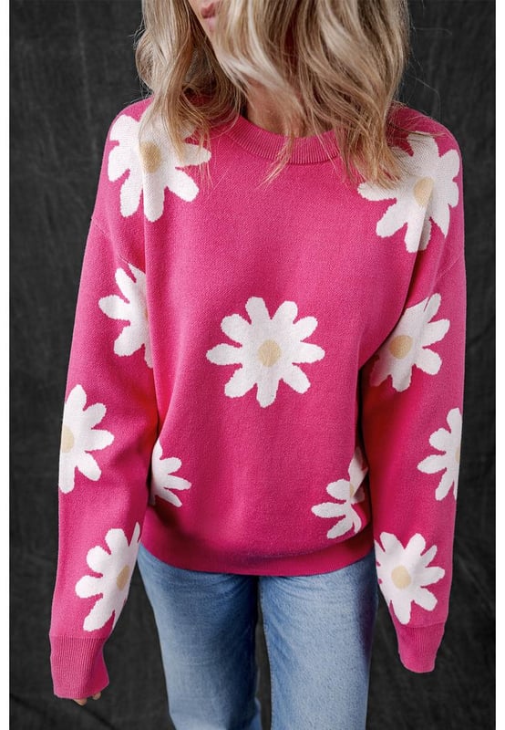 Impresión de flores de margarita en rosa brillante  
Cuello redondo clásico  
Mangas largas  
Construcción de punto con ribete acanalado  
Material: 57% Viscosa 27% Poliéster 16% Poliamida