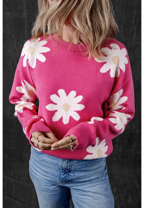 Impresión de flores de margarita en rosa brillante  
Cuello redondo clásico  
Mangas largas  
Construcción de punto con ribete acanalado  
Material: 57% Viscosa 27% Poliéster 16% Poliamida