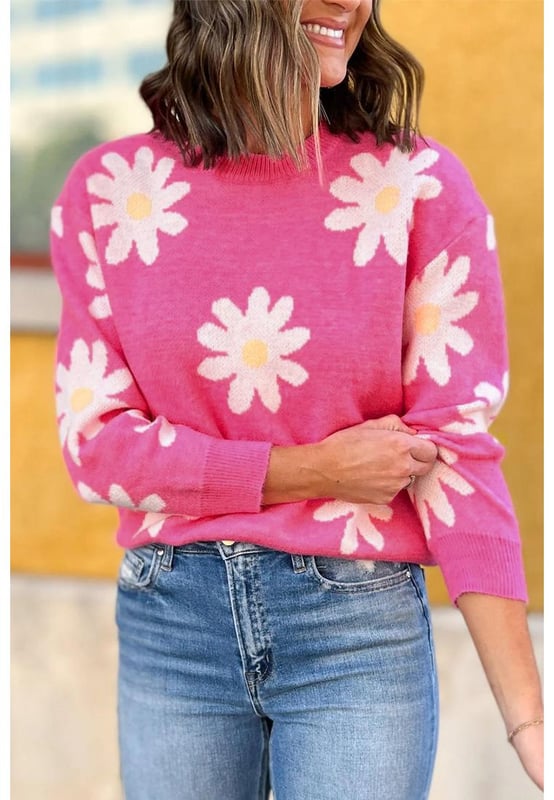 Impresión de flores de margarita en rosa brillante  
Cuello redondo clásico  
Mangas largas  
Construcción de punto con ribete acanalado  
Material: 57% Viscosa 27% Poliéster 16% Poliamida