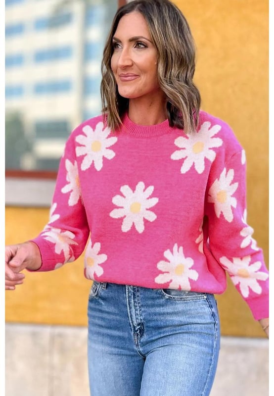 Impresión de flores de margarita en rosa brillante  
Cuello redondo clásico  
Mangas largas  
Construcción de punto con ribete acanalado  
Material: 57% Viscosa 27% Poliéster 16% Poliamida