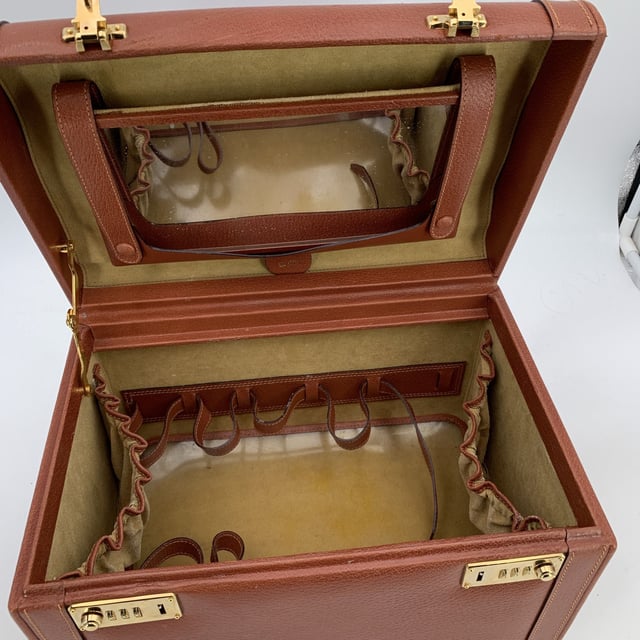 VINTAGE, RRP AS NEW
Discover a true vintage treasure with this one-of-a-kind brown leather beauty train case by Gucci, dating back to the early 1990s. A stunning example of classic luxury, this train case is crafted from rich, supple leather and accented with gleaming gold brass hardware, creating a striking contrast that highlights the craftsmanship of its era. The double combination lock closure, currently set to '000,' ensures your precious items are securely stored, while the four protective bottom feet maintain its pristine Condition Rating: B - VERY GOOD CONDITIONCondition Details: Some scratches on leather due to normal use. Some normal wear of use on the internal lining. Some small white spots on the surface of the mirror. The lid is slightly recessed. Please check the photos carefully and ask if you need to know more details or if you have any doubts.Measurements (cm):Depth: 22.9Height: 24.1Length: 34.3Other Details: Dustbag? NoKeys? NoBox? No Measurments:  width: 229 mm length: 343 mm height: 241 mm